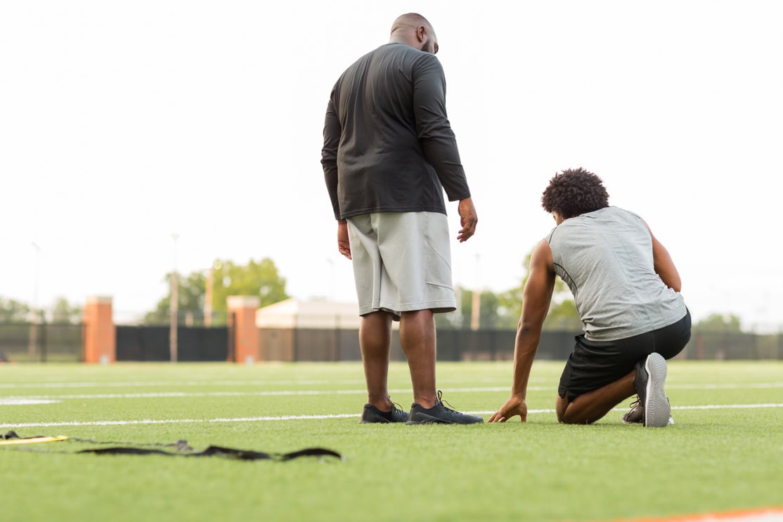 American Football Coach Training a Young Athlete.