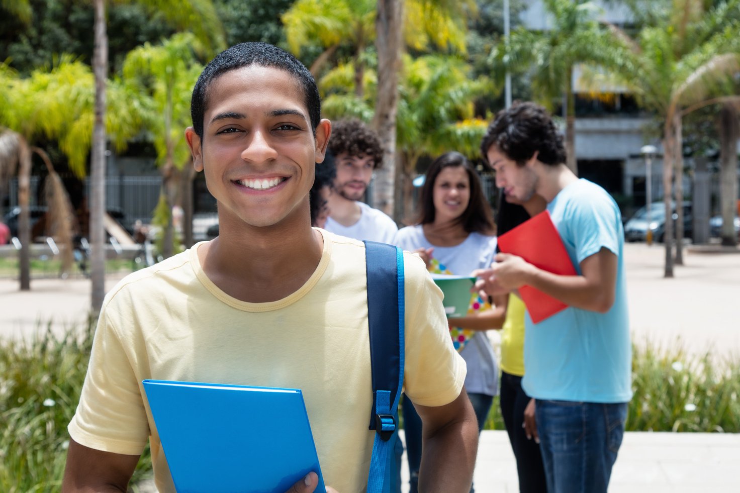 Happy egyptian scholarship student with group of international students