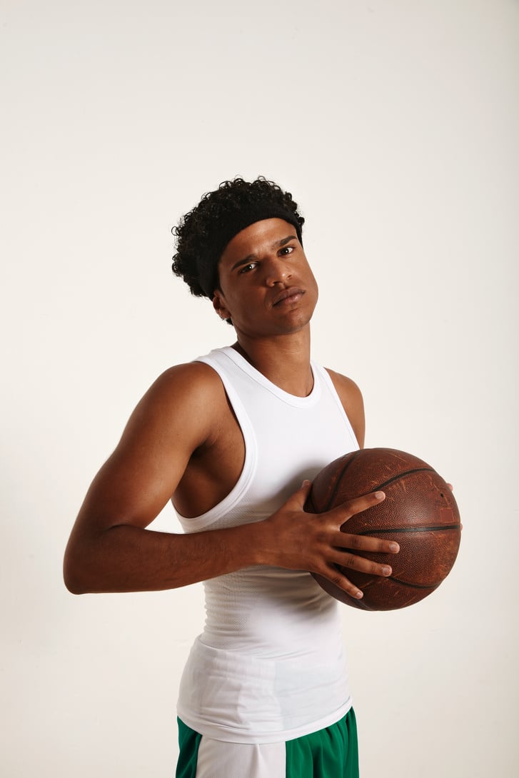 Young black athlete holding a basketball