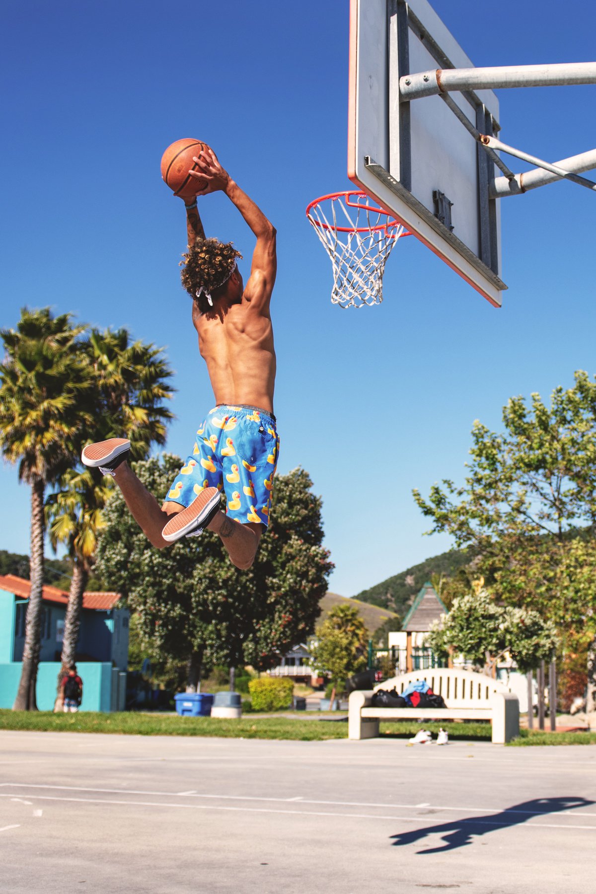 Man Wearing Blue and Yellow Shorts Playing Basketball